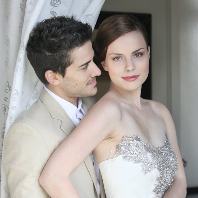 Stylish bride and groom posing indoors