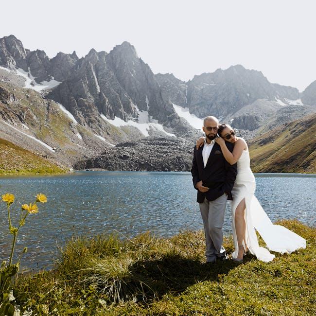 Bride and groom by mountain lake